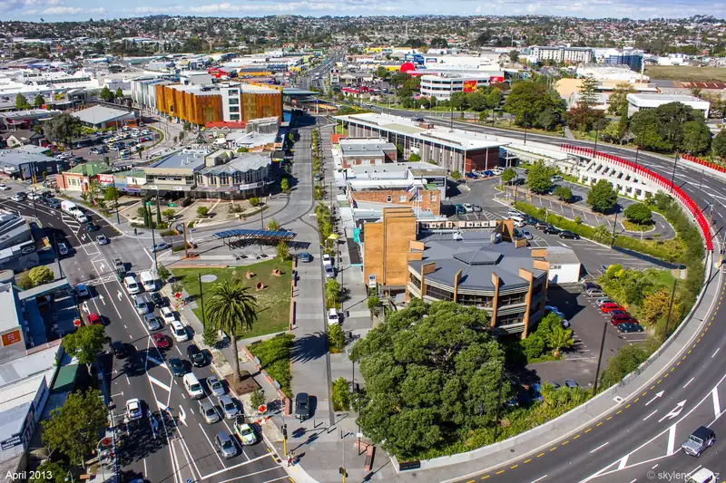 Aerial view of New Lynn town centre in April 2013 showing the station area, shops and newer buildings