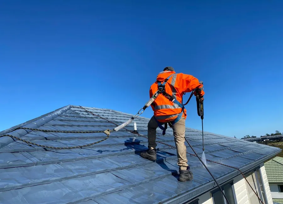 Professional roof cleaning on an Auckland home removing moss and built-up grime